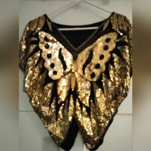 1976 Gold rhinestone covered silk creating a butterfly front and back.